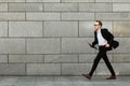 Young man in suit with folder is jumping to new job. Unlimited happiness and joy Royalty Free Stock Photo