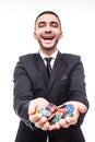 Young man in suit holding up win poker chips at game Royalty Free Stock Photo