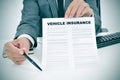 Young man in suit showing a vehicle insurance policy Royalty Free Stock Photo