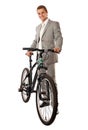 Young man in a suit standing next to a bike