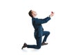 Young man in suit standing on one knee and making marriage proposal Royalty Free Stock Photo