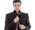 Young man in a suit, tie a tie. Royalty Free Stock Photo