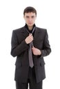 A young man in a suit, tie a tie. Royalty Free Stock Photo