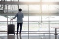 Young man with suitcase luggage in airport terminal Royalty Free Stock Photo