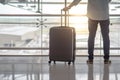 Young man with suitcase luggage in airport terminal Royalty Free Stock Photo