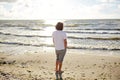 Young man on summer beach looking at sea Royalty Free Stock Photo