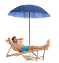 Young man on sun lounger under umbrella against white background. Beach Royalty Free Stock Photo