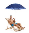 Young man on sun lounger under umbrella against white background. Beach Royalty Free Stock Photo