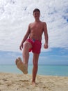 Young man sunbathing on the beach in the Caribbean sea Royalty Free Stock Photo