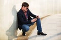 Young man in sunglasses looking at mobile phone Royalty Free Stock Photo