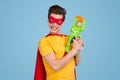 Funny superhero with toy gun Royalty Free Stock Photo