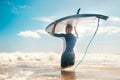 Young Man surfer with long board on head goes to the sea to have a surf practice. Learning surfing concept
