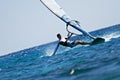 Young man surfing the wind in splashes of water Royalty Free Stock Photo