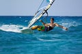 Young man surfing the wind in splashes of water Royalty Free Stock Photo