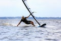 Young man surfing the wind in splashes of water Royalty Free Stock Photo