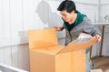 Young man surprised opening box and looking inside and unpacking the package received online shopping parcel opening boxes buying Royalty Free Stock Photo