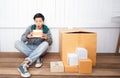 Young man surprised opening box and looking inside and unpacking the package received online shopping parcel opening boxes buying Royalty Free Stock Photo