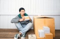 Young man surprised opening box and looking inside and unpacking the package received online shopping parcel opening boxes buying Royalty Free Stock Photo