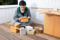 Young man surprised opening box and looking inside and unpacking the package received online shopping parcel opening boxes buying Royalty Free Stock Photo