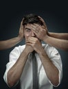 A young man surrounded by hands like his own thoughts