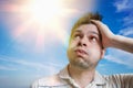 Young man is sweating. Hot weather concept. Sun in background Royalty Free Stock Photo