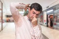 Man with sweating under armpit in shopping center Royalty Free Stock Photo