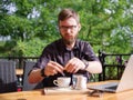 A young man sweetens his drink in a cafe Royalty Free Stock Photo