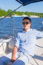 Young man swiming and resting on his yacht at Royalty Free Stock Photo