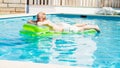 Young man is swimming with air mattress in pool Royalty Free Stock Photo