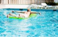 Young man is swimming with air mattress in pool Royalty Free Stock Photo