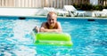 Young man is swimming with air mattress in pool Royalty Free Stock Photo