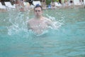 Young man swimming in oceans water. Man On Beach In Summer. Handsome Male With Fit Body, Royalty Free Stock Photo