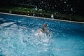 Young man swimming in the swimming pool splashing water. Up viiew Royalty Free Stock Photo