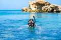 Young man swimming in snorkeling mask at clear azure sea Royalty Free Stock Photo