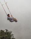 Young man Swinging at Casa del Arbol, Banos Ecuador Royalty Free Stock Photo