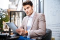 Young man with tablet pc touch in a cafe outdoor Royalty Free Stock Photo