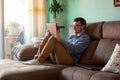 Young man with tablet on sofa at home