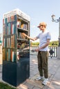 Young man takes books from a free book exchange point. Rostov-on-Don, Russia, august 07 2021