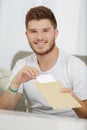 Young man taking letter from envelope Royalty Free Stock Photo