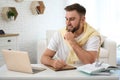 Young man taking notes during webinar at table indoors Royalty Free Stock Photo