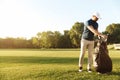 Young man taking out golf club from a bag Royalty Free Stock Photo