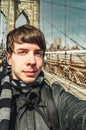 Young man taking photo on brooklyn bridge Royalty Free Stock Photo