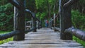 The young man is taking a photo shoot on the wooden bridge, at Pang Ung traveling to take pictures of natural scenery