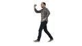 Young man taking photo with smartphone while walking on white background. Royalty Free Stock Photo
