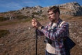 Young man taking photographs with digital camera in a mountains. Royalty Free Stock Photo