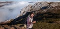 Young man taking photographs with digital camera in a mountains. Royalty Free Stock Photo