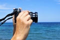 Young man taking a picture in front of the sea Royalty Free Stock Photo