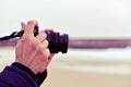 Young man taking a picture in front of the sea Royalty Free Stock Photo