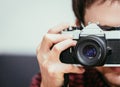 Young man is taking a picture with a vintage camera Royalty Free Stock Photo