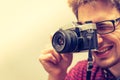 Young man is taking a picture with a vintage camera Royalty Free Stock Photo